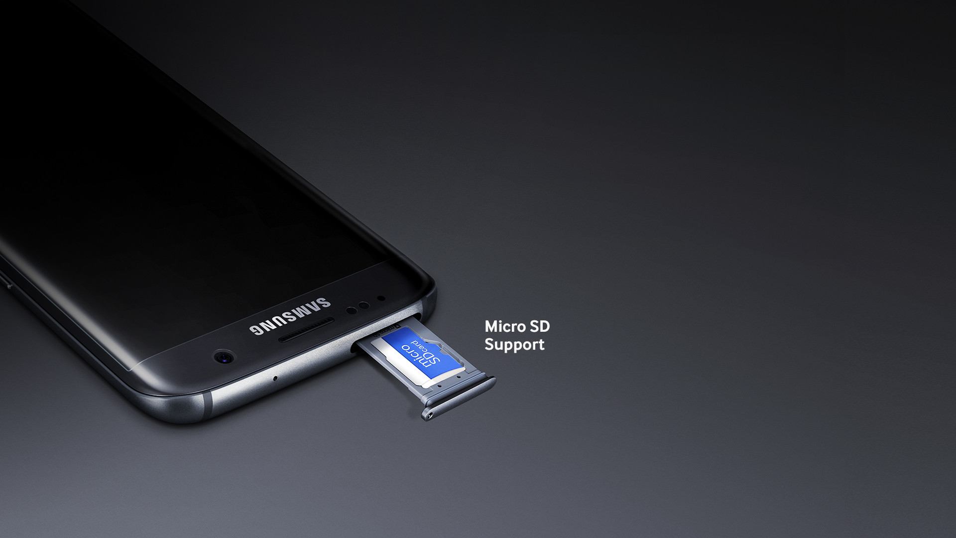 A close-up detail of the Galaxy S7 edge (black), showing a microSD card inside the device's microSD slot, along with the text 'microSD support'.