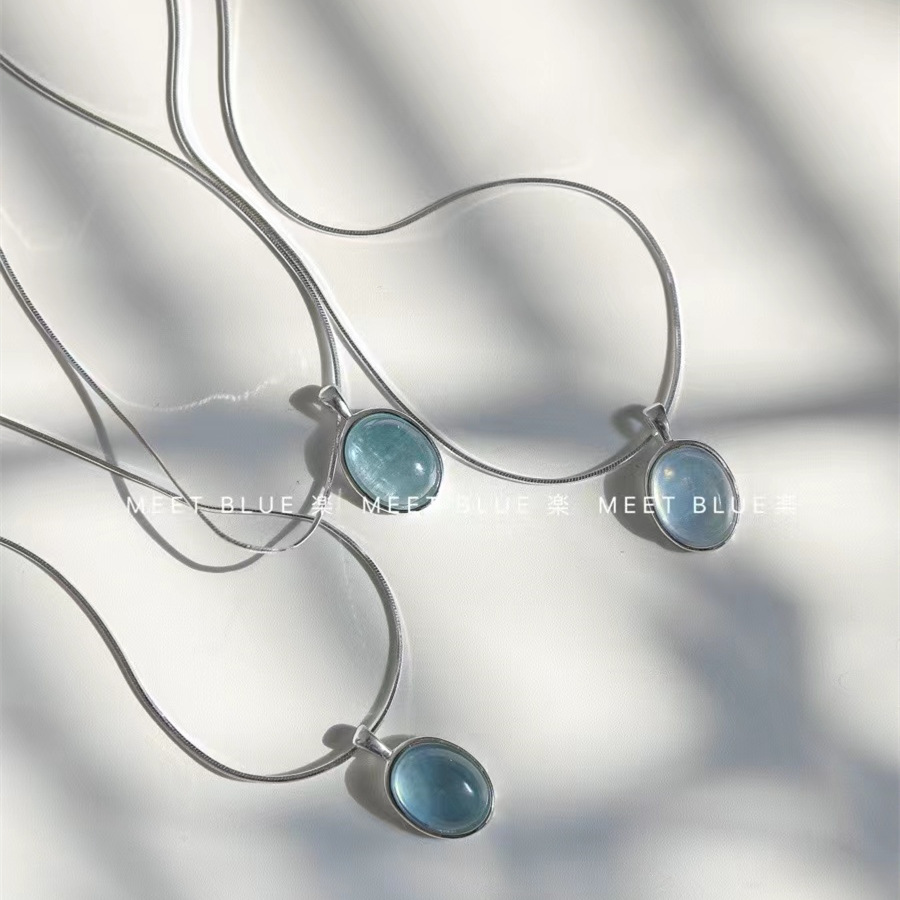 Aquamarine egg-shaped crystal necklace ins niche simple oval water drop pendant temperament versatile light luxury snake bone chain. 