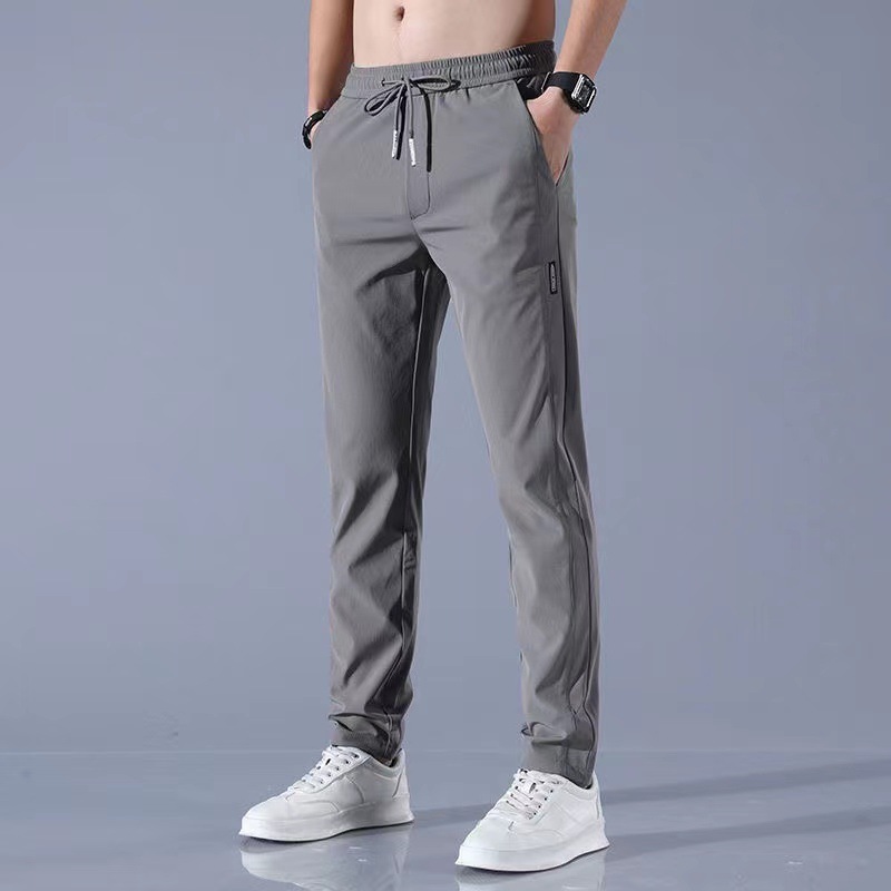 Xia Xiu thin ice silk casual pants men's work trend loose straight breathable sports cropped pants men. 