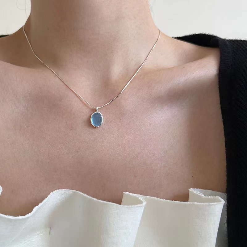 Aquamarine egg-shaped crystal necklace ins niche simple oval water drop pendant temperament versatile light luxury snake bone chain. 