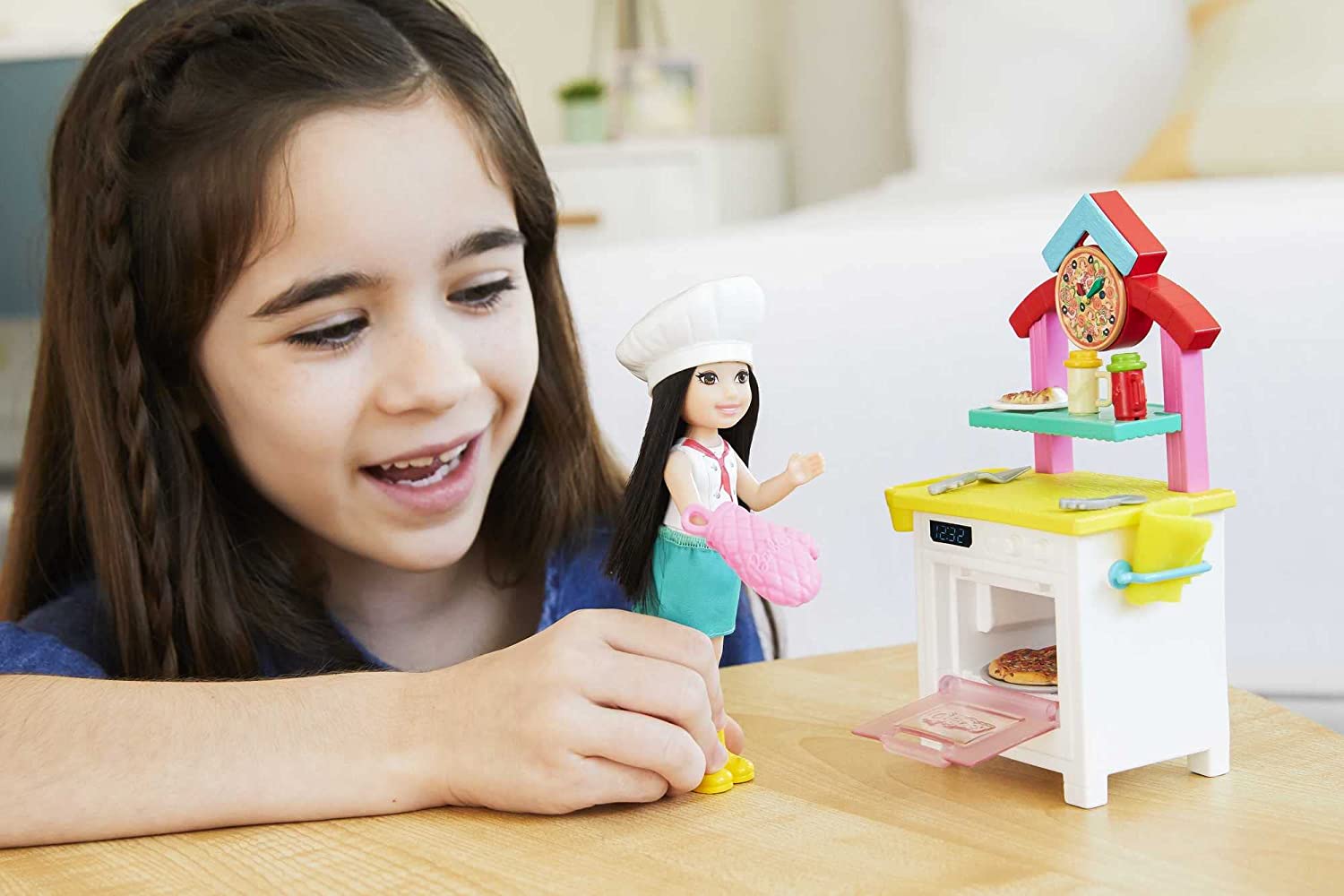 Barbie GTN63​ Chelsea Can Be Pizza Chef Playset with Brunette Chelsea Doll (6-in/15.24-cm), Pizza Oven, 2 Spice Shakers, Pizza Pan & More. 