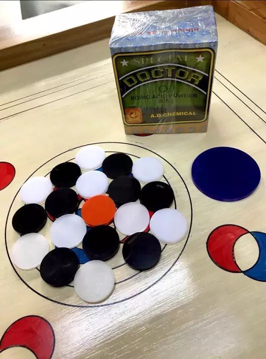 Carrom Coin Set with Striker. 